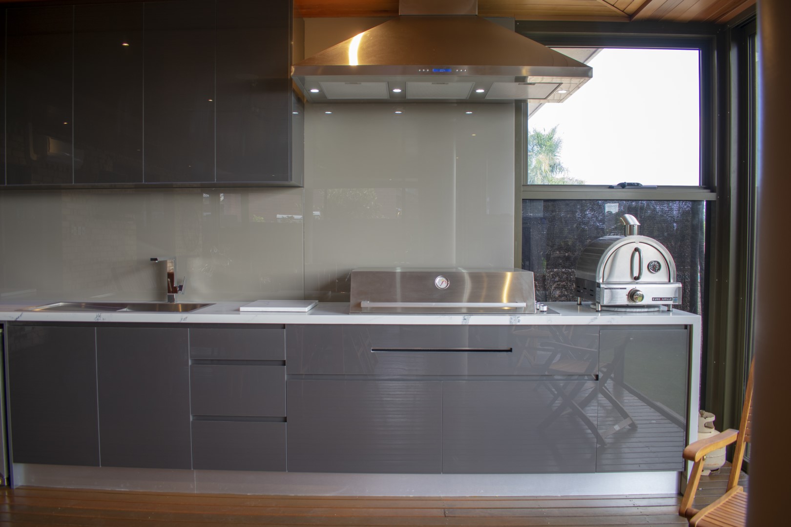 Modern grey gloss cabinets with feature copper extraction fan