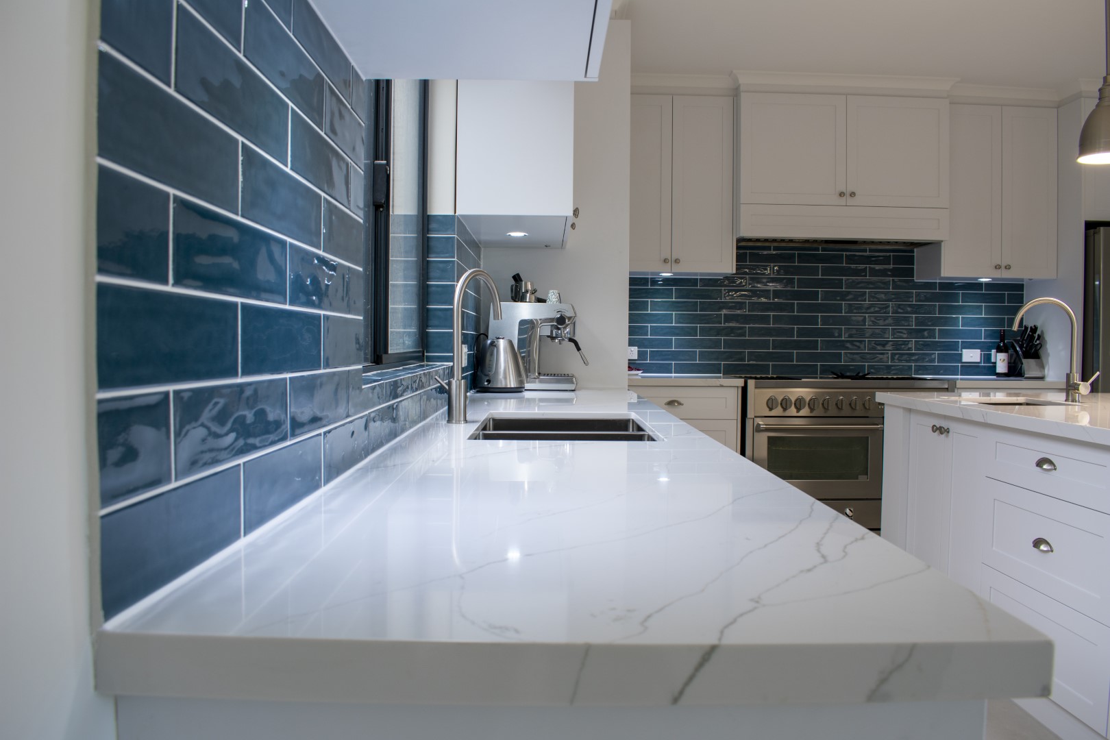 Benchtop and blue tiled splashback