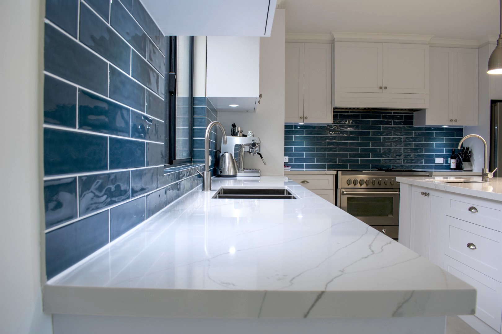 Kitchen with stylish glossy blue splashback tiles